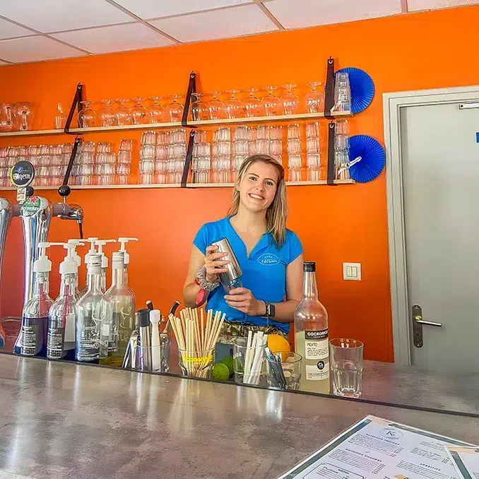 Serveuse au comptoir du Kerac bar du camping en Vendée